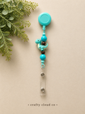 Teal Dinosaur Badge Reel